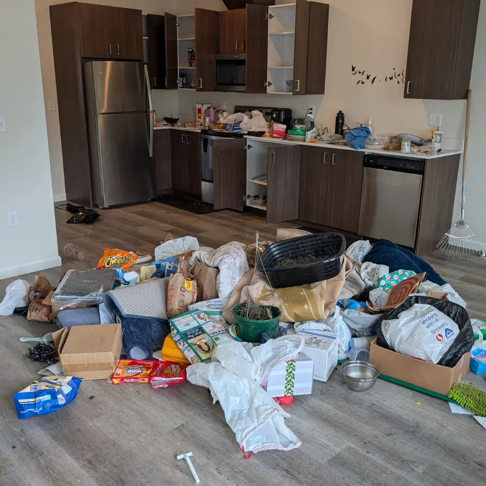 Pile of household debris in middle of floor from eviction cleanout.