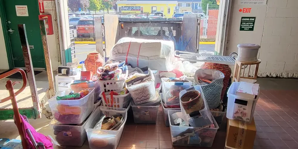 commercial cleanout of storage unit with staged housewares by door ready to be loaded and recycled
