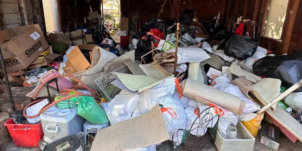 Garage full of junk, household goods and recyclables before cleanout with Patriot Hauling and Junk LLC