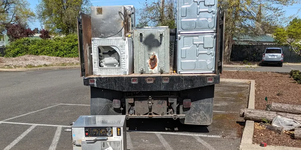 Patriot Hauling & junk removal Truck filled with commercial appliances for recycling.