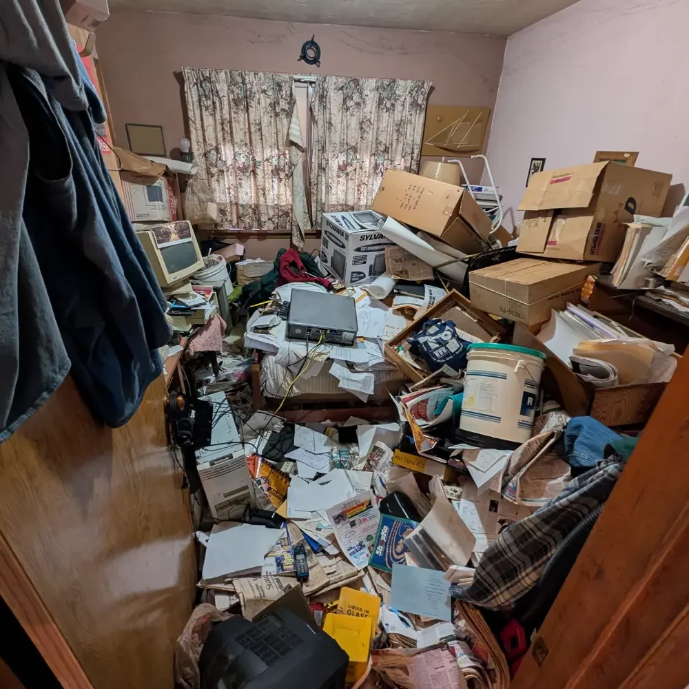 Bedroom filled with junk before junk removal