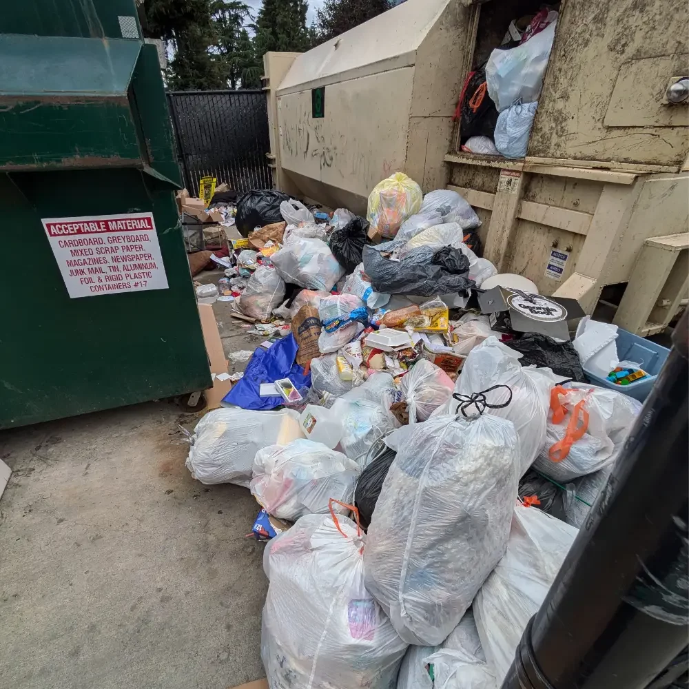 Overflowing trash compactor at apartment complex in Salem Oregon