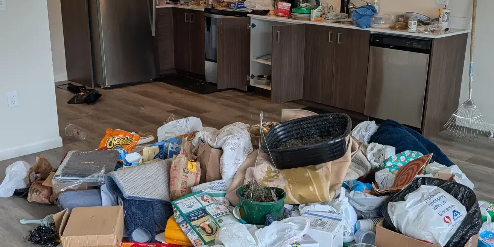 Pile of household debris in middle of floor from eviction cleanout.
